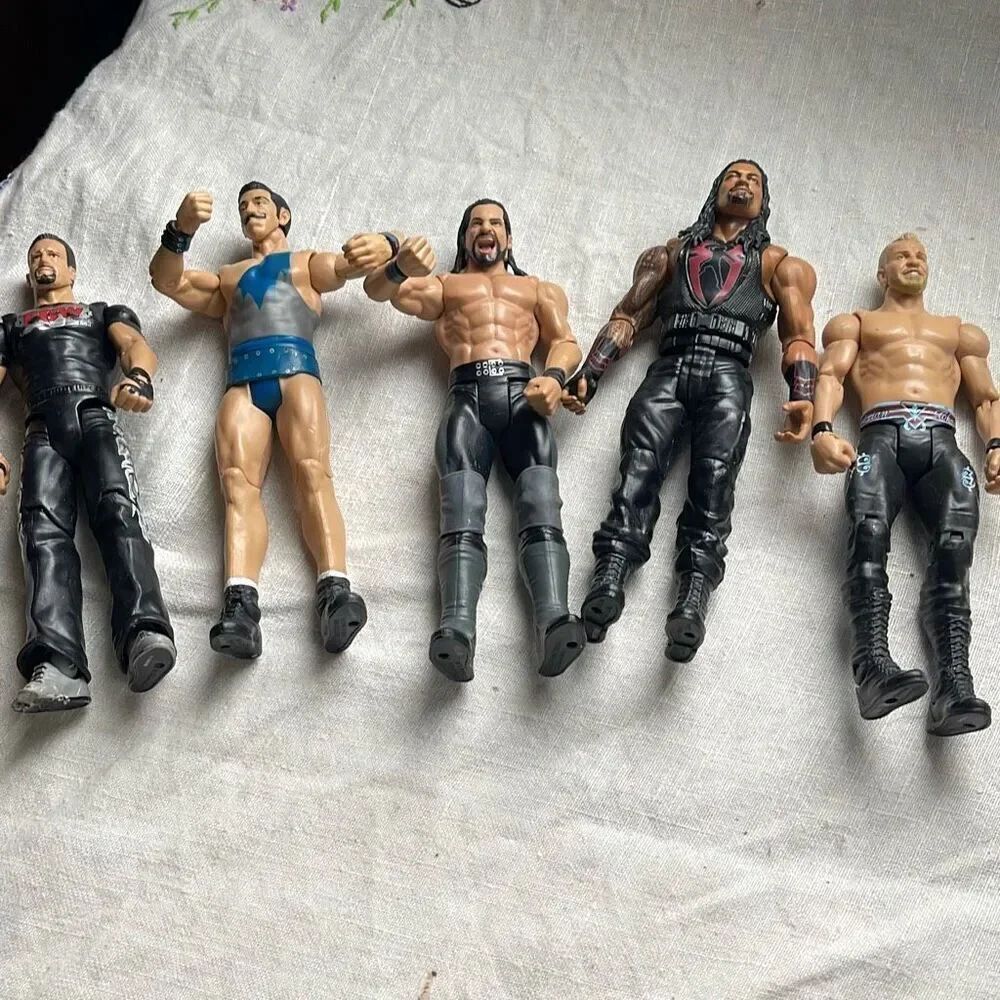 Lot of 5 WWE wrestling action figures Mattel one broken foot .